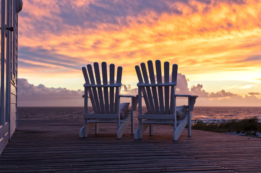 Two Ampty Chairs Facing Magnificent Sunset View at Beach